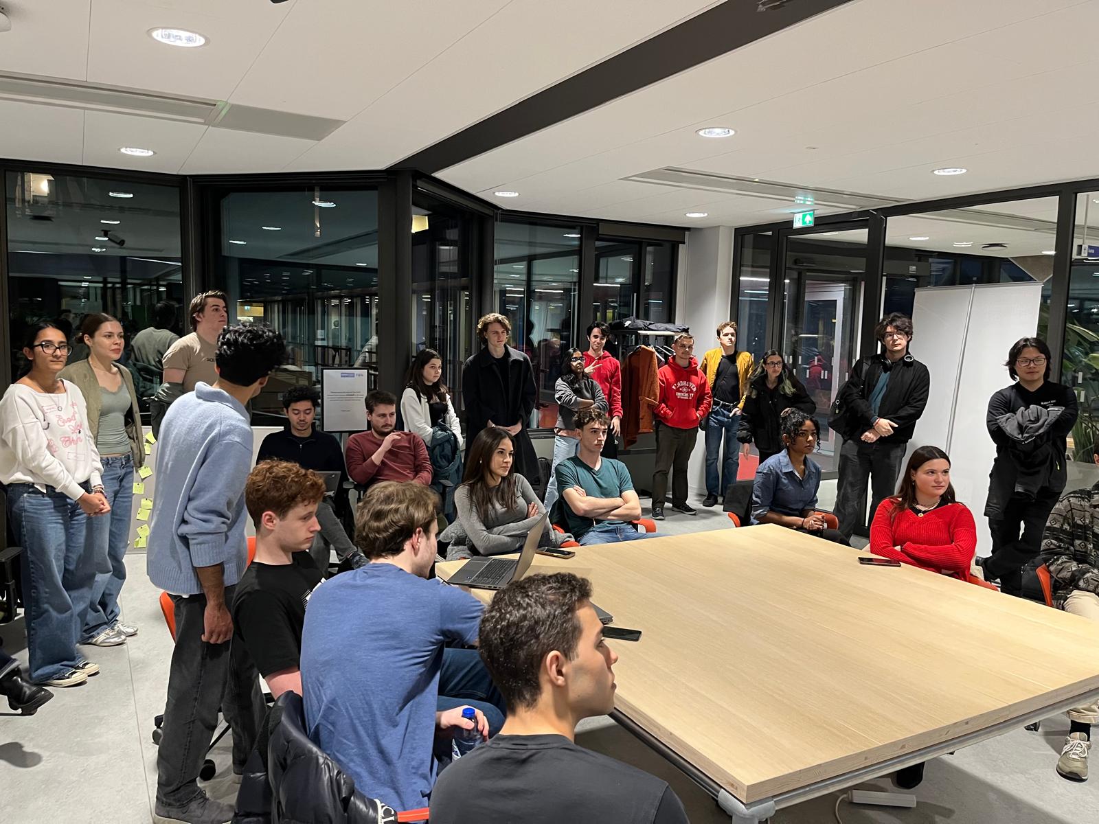 Serpentine AI members gathered around a table during a community evening